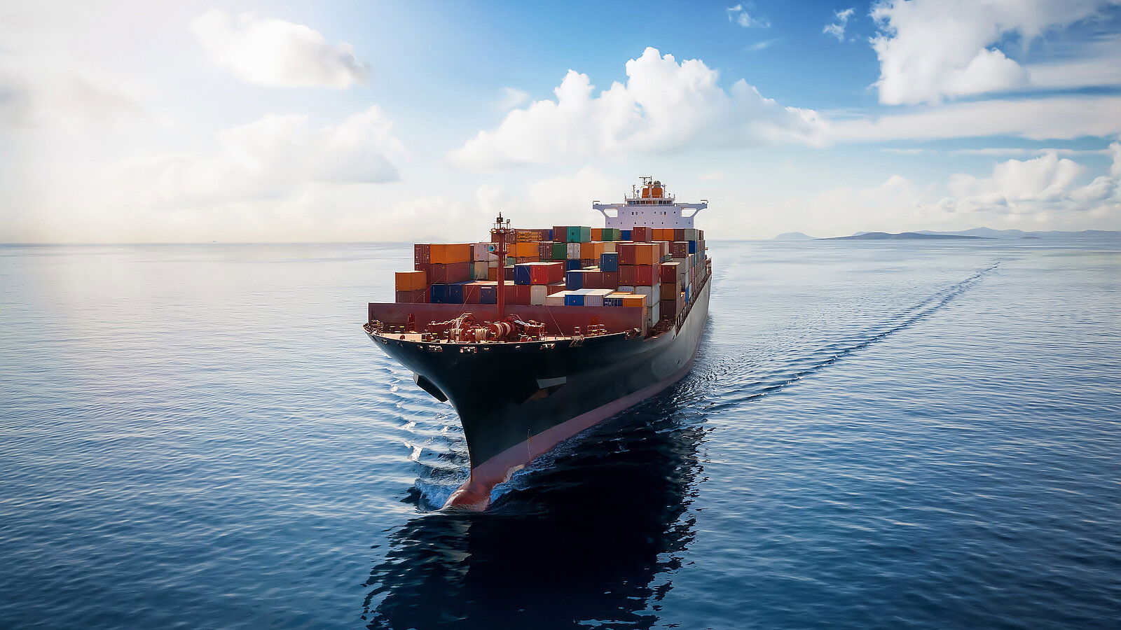 Aerial view of a container cargo ship traveling over open ocean